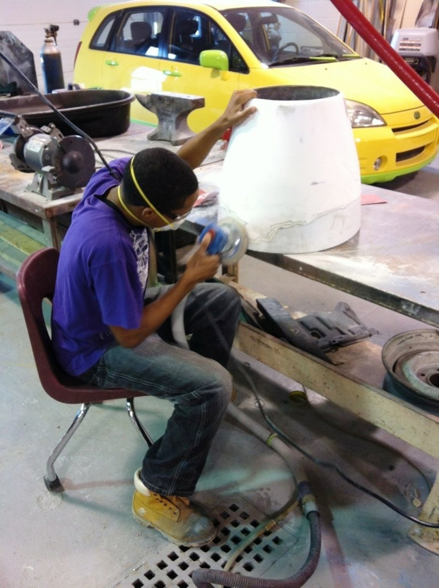 A student from the Western Area Career and Technology Center works on the 311th Recruiting Squadrno's mini-jet, “Aggressor 1.” The 311 RCS partnered with WACTC students to refurbish the squadron's marketing asset. (U.S. Air Force photo/Master Sgt. Michael McMillen)