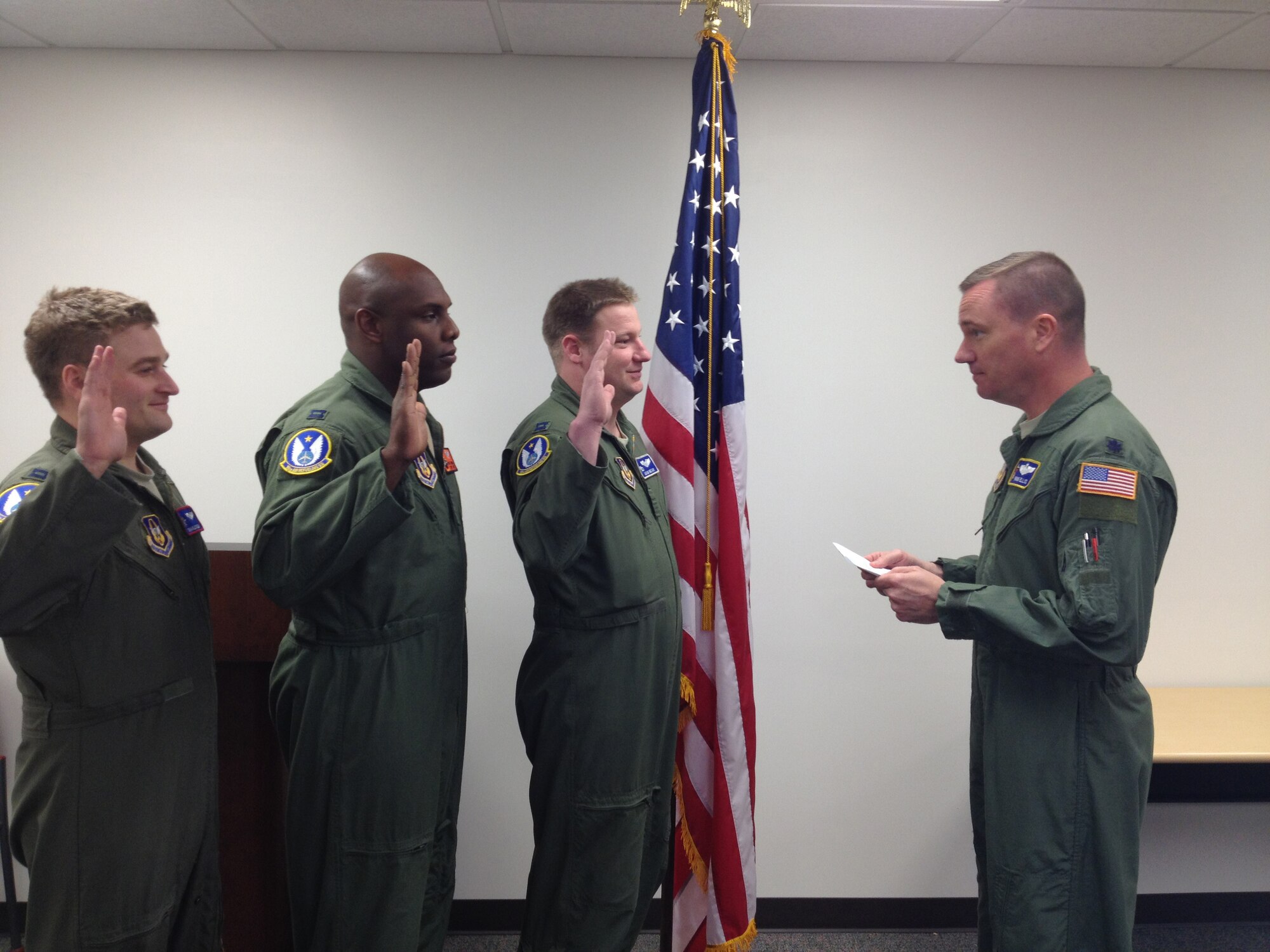 Lt. Col. Frank Ellis, 18th Air Refueling Squadron, swears in three new 18th ARS members (left to right) Capt. Charles Hein, Capt. Will Watson and Capt. Adam Wear, March 4. The captains are former active duty Air Force officers who recently transferred to the Air Force Reserve. Ellis, who commissioned in 1996 is the longest serving aircrew member in the 18th ARS. (Air Force photo by Lt. Col. Tsuyoshi Tung)