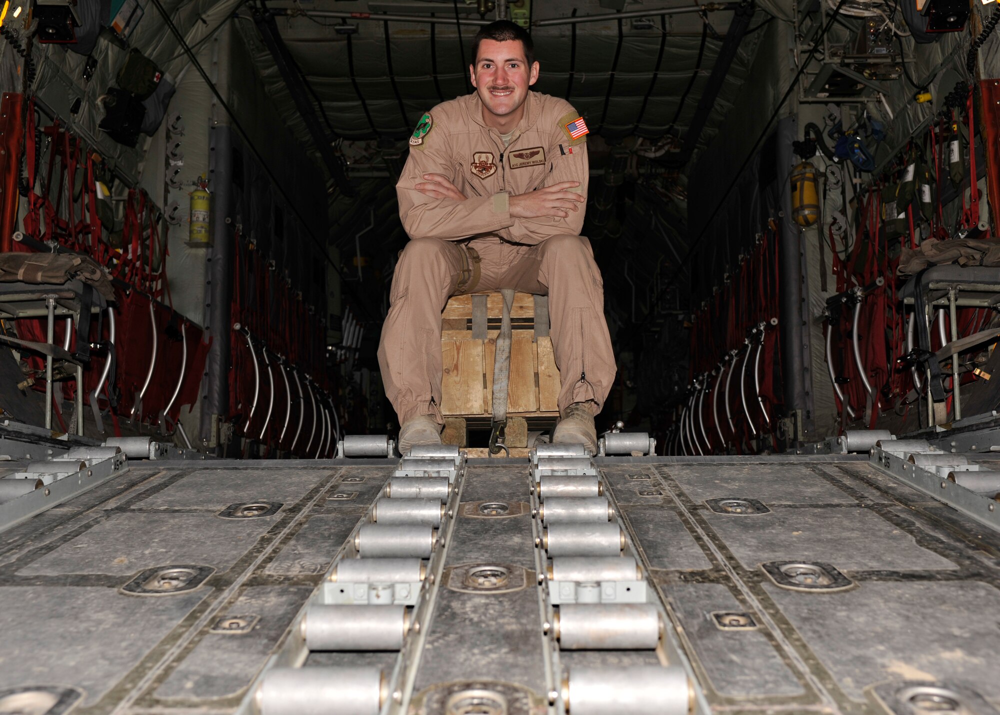 BAGRAM AIRFIELD, Afghanistan—Airman 1st Class Jeremy Wolski poses on the ramp of a C-130 aircraft after receiving the Warrior of the Week award at Bagram Airfield, Afghanistan, March 6, 2012. Wolski is a load master with the 774th Expeditionary Airlift Squadron and is deployed from the 302nd Airlift Wing, Colorado Springs, Colo. (U.S. Air Force photo/Airman 1st Class Ericka Engblom)