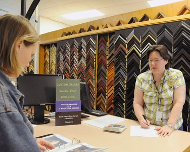 Joan Fennigkoh, 902nd Force Support Squadron recreational aide, helps a customer make a frame selection at the Joint Base San Antonio-Randolph arts and crafts hobby shop Feb. 28. (U.S. Air Force photo by Don Lindsey)