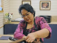 Christy Sanchez 902nd Force Support Squadron custom picture framer, assembles  frame for a customer at the Joint Base San Antonio-Randolph arts and crafts hobby shop Feb. 28.  ( U.S. Air Force Photo by Don Lindsey)