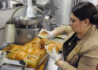 Bea Jordon, 902nd Force Support Squadron caterer, prepares dinner rolls for a luncheon at the Kendrick Club, Joint Base San Antonio-Randolph Feb. 28. (U.S. Air Force Photo by Don Lindsey)