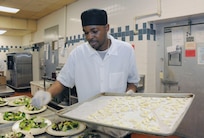 Joseph Patterson, 902nd Force Support Squadron cook, prepares a salad for a luncheon at the Kendrick Club -Joint Base San Antonio-Randolph Feb. 28. (U.S. Air force Photo by Don Lindsey)
