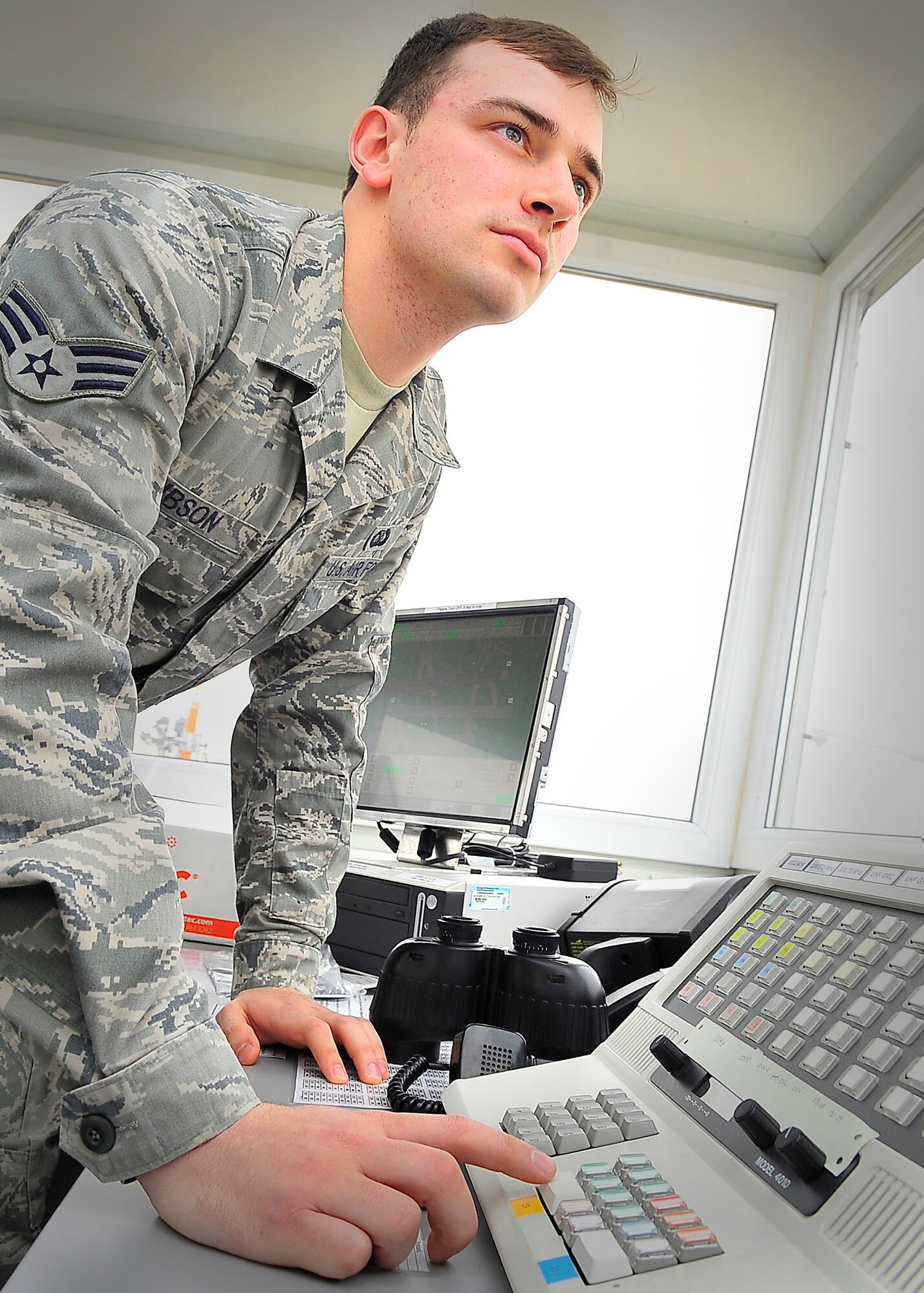 86th Operational Support Squadron, Air Traffic Controller, Senior Airmen Kyle Gibson completes radio transmission adjustments during an operations check from the the new alternate Air Traffic Control facility near the flight-line, Ramstein Air Base, Germany, March 2, 2012.  (U.S. Air Force photo/Staff Sgt. Daylena Gonzalez)