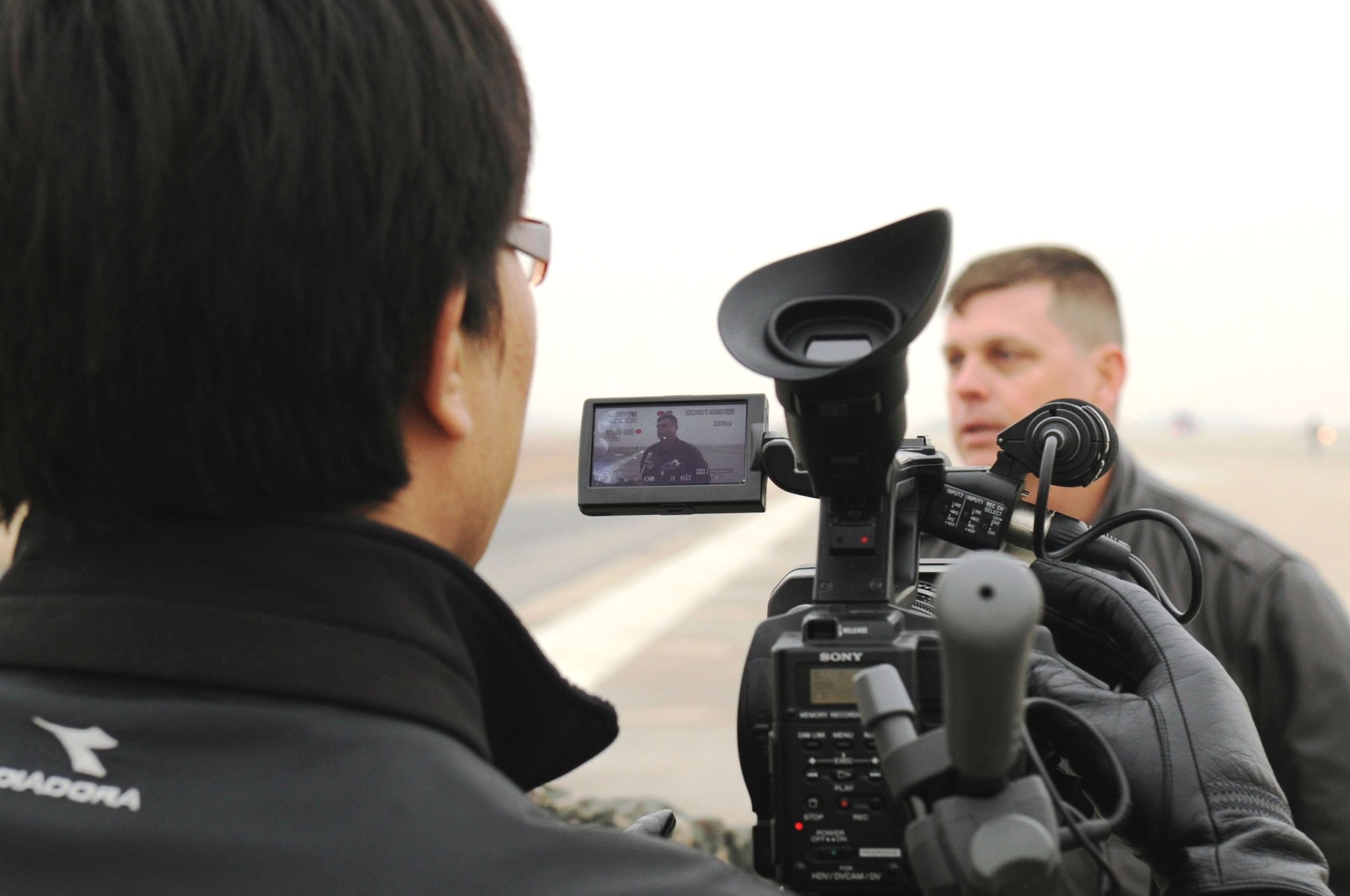 Col. Craig Leavitt, 8th Operations Group commander, is interviewed by local Korean media March 2, 2012, during a combat generation exercise on Kunsan Air Base, Republic of Korea. The exercise, referred to as an “Elephant Walk,” brought together fighter aircraft from five combined units from both American and Korean Air Forces. (U.S. Air Force photo by Senior Airman Jessica Hines/Released)