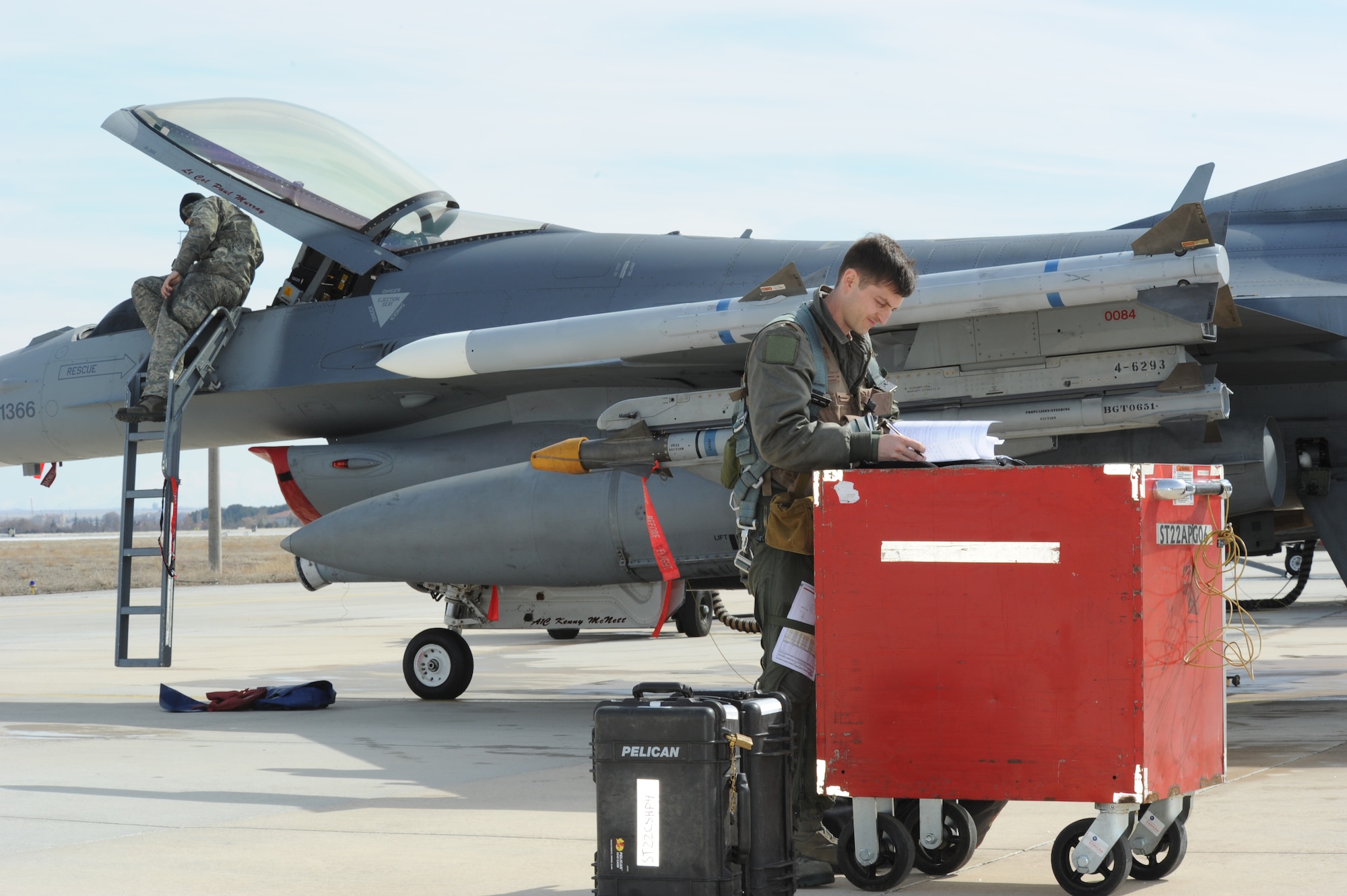 KONYA, Turkey -- Maj. Brian Scott, F-16 Fighting Falcon pilot, reviews a preflight checklist while Airman 1st Class Kenneth McNett, 52nd Aircraft Maintenance Squadron crew chief, during exercise Anatolian Falcon 2012. During the bilateral training exercise the squadron will fly missions including air interdiction, attack, air superiority, defense suppression, airlift, air refueling and reconnaissance. (U.S. Air Force photo/Staff Sgt. Benjamin Wilson)