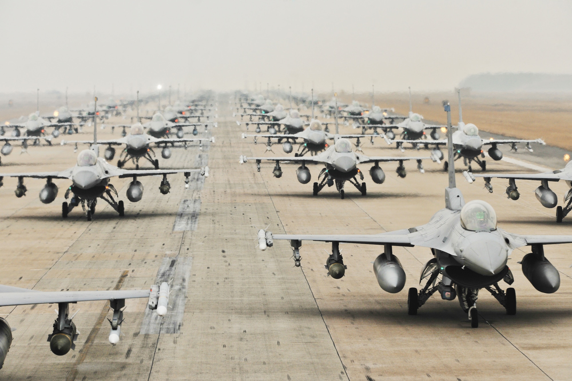 F-16 Fighting Falcons from the 35th and 80th Fighter Squadrons of the 8th Fighter Wing, Kunsan Air Base, Republic of Korea; the 421st Expeditionary Fighter Squadron of the 388th FW at Hill Air Force Base, Utah; the 55th EFS from the 20th FW at Shaw AFB, S.C.; and from the 38th Fighter Group of the ROK Air Force, demonstrate an “Elephant Walk” as they taxi down a runway during an exercise at Kunsan Air Base, Republic of Korea, March 2, 2012. The exercise showcased Kunsan AB aircrews' capability to quickly and safely prepare an aircraft for a wartime mission. (U.S. Air Force photo by Senior Airman Brittany Y. Auld/Released)