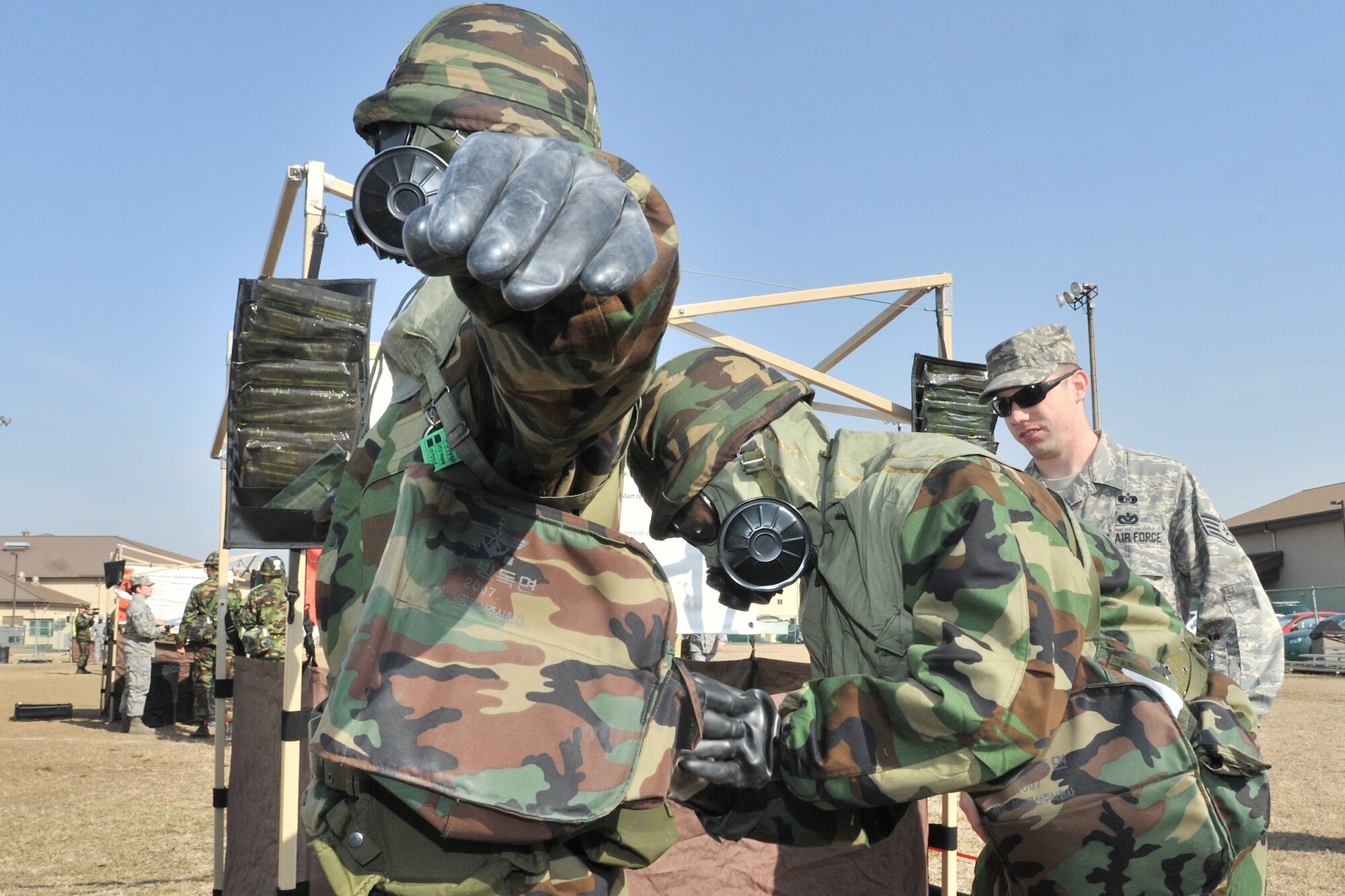 Republic of Korea Air Force and Army personnel use an M295 decontamination packet during counter chemical, biological, radiological, nuclear and explosive training led by 8th Civil Engineer Squadron readiness and emergency management flight at Kunsan Air Base, ROK Feb. 29, 2012. Joint training with ROK forces happens twice a year. (U.S. Air Force photo by Senior Airman Brittany Y. Auld/Released)
