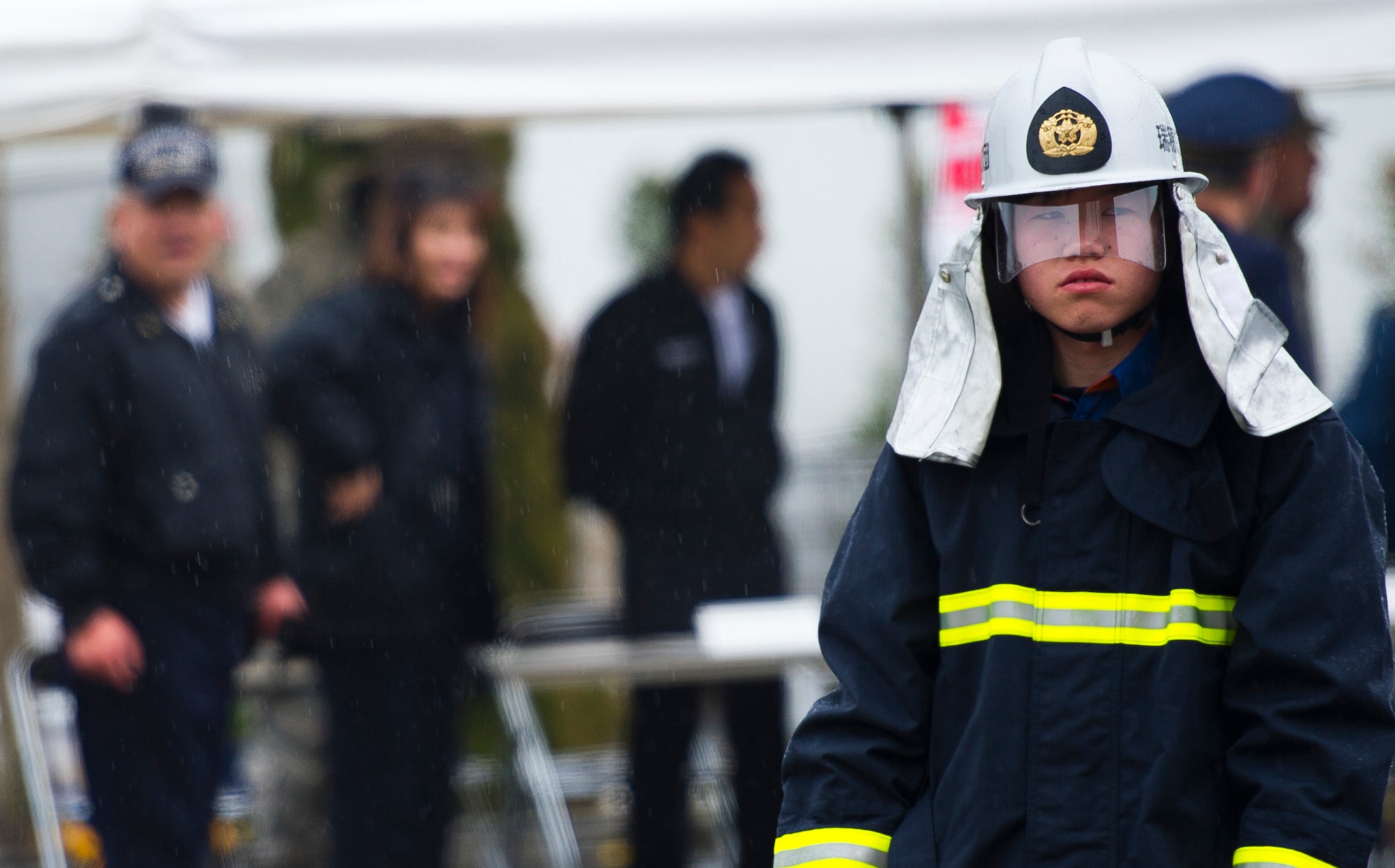 YOKOTA AIR BASE, Japan -- A Japanese firefighter with the Tokyo Fire Department receives instructions during the Fussa Fire Department Rescue Response Exercise outside a Japanese department store March 2, 2012. Fussa, Hamura, Mizuho and Yokota firefighters participated in the one-hour event showcasing their ability to respond to an emergency. (U.S. Air Force photo/Staff Sgt. Chad C. Strohmeyer)