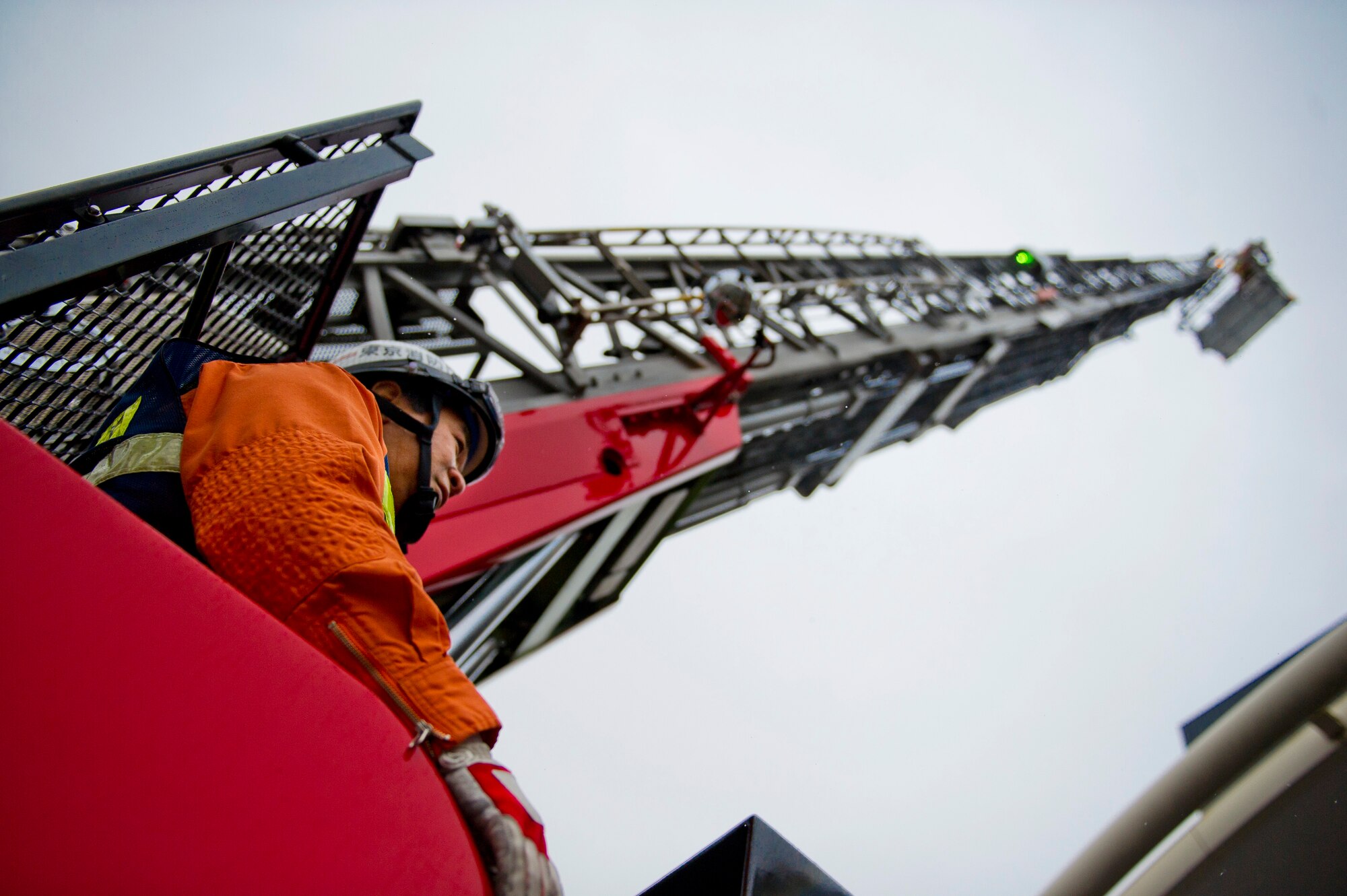 YOKOTA AIR BASE, Japan -- A Japanese firefighter with the Tokyo Fire Department, operates a "cherry picker" to simulate the rescue of people unable to exit a building during the Fussa Fire Department Rescue Response Exercise outside a Japanese department store March 2, 2012. Fussa, Hamura, Mizuho and Yokota firefighters participated in the one-hour event showcasing their ability to respond to an emergency. (U.S. Air Force photo/Staff Sgt. Chad C. Strohmeyer)