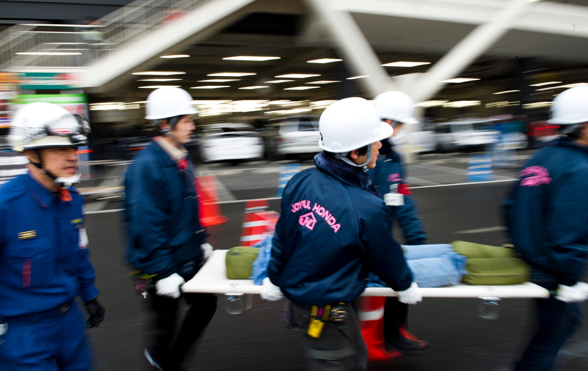 YOKOTA AIR BASE, Japan -- Japanese staff members at a department store assist firefighters during the evacuation of simulated victims during the Fussa Fire Department Rescue Response Exercise outside a Japanese department store March 2, 2012. Fussa, Hamura, Mizuho and Yokota firefighters participated in the one-hour event showcasing their ability to respond to an emergency. (U.S. Air Force photo/Staff Sgt. Chad C. Strohmeyer)