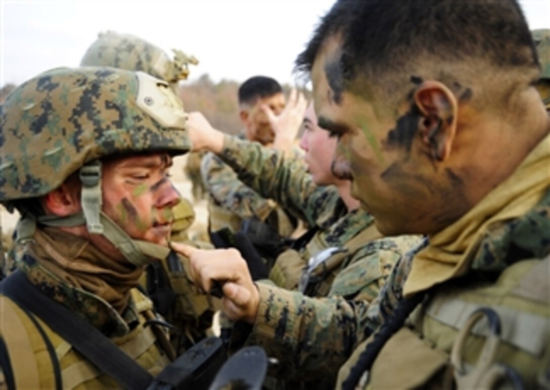Cpl. Mario Melendez (right), assigned to 2nd Platoon, Company Pacific, Fleet Anti-Terrorism Security Team applies camouflage paint to Lance Cpl. Tyler Courtney before a tactical movement exercise at Camp Rodriguez, Republic of Korea, on March 3, 2012.   Approximately 50 Marines conducted training at the Camp Rodriguez Live Fire Complex.  