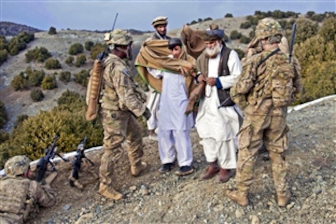 U.S. Army Staff Sgt. Omar Jackson, left, and U.S. Army 2nd Lt. Ross Hines greet Afghans while on a patrol near Enzarkay Pass in Afghanistan's Paktya province, March 2, 2012. Jackson and Hines are assigned to Company A, 3rd Battalion, 509th Infantry Regiment.