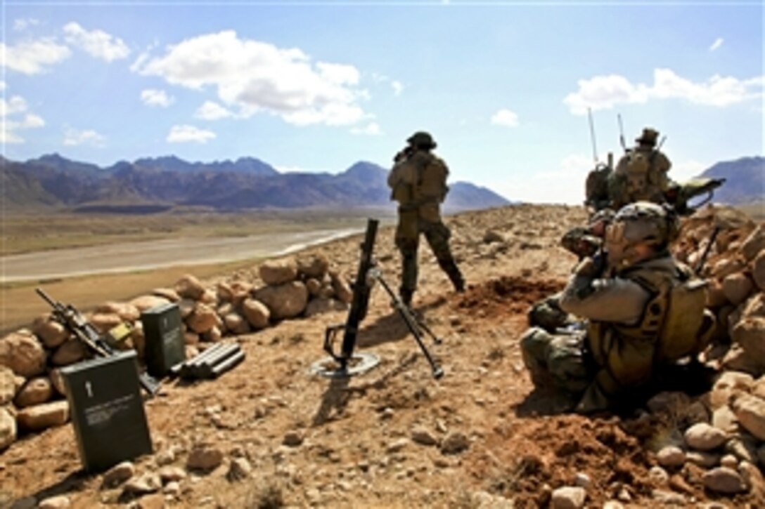 U.S. coalition special operations forces members provide security during a two-day presence patrol with Afghan commandos in Sar-e Takht village in Afghanistan's Farah province, Feb. 27, 2012.