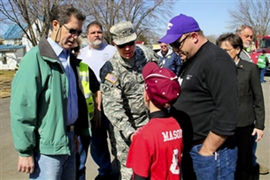 Kansas Gov. Sam Brownback, left, and Army Maj. Gen. Lee Tafanelli, Kansas National Guard adjutant general and director of the Division of Emergency Management, speak with a boy in Harveyville, Kan., March 2, 2012, after an EF2 tornado struck the area two days earlier. Brownback visited Harveyville to inspect the damage and meet with residents. The storm killed one person and injured more than a dozen others as it cut a 5-mile path through the town. 