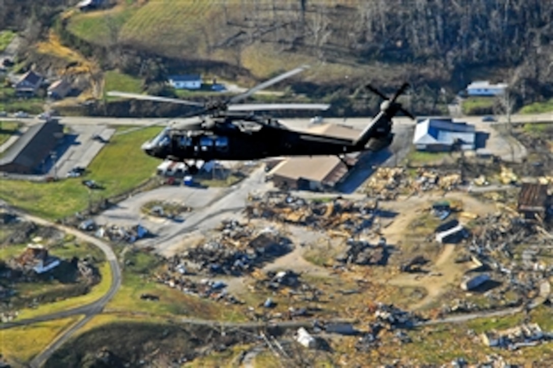 An Army UH-60 Black Hawk helicopter carries Kentucky Gov. Steve Beshear as he views damage in West Liberty, Ky., March 3, 2012, after a tornado hit the town the previous day. About 220 Kentucky Guardsmen assisted in five counties in eastern Kentucky following the tornados that struck the area.