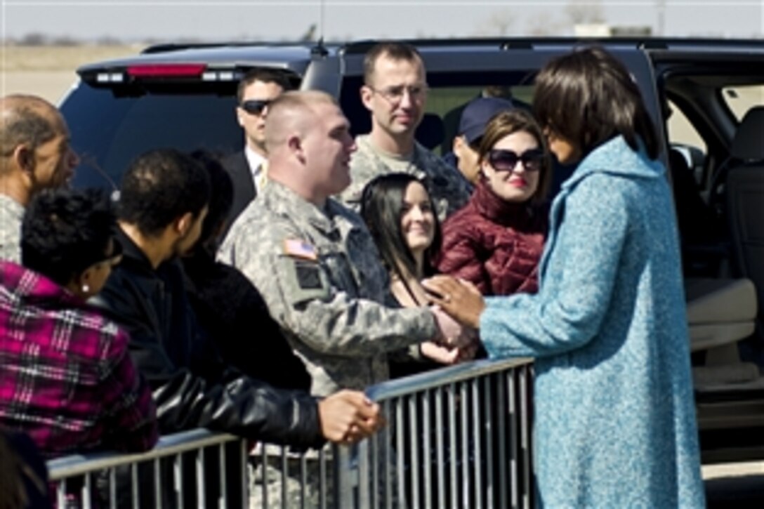 First Lady Michelle Obama shakes hands with Army Staff Sgt. Andrew Schueller at Kansas City International Airport in Kansas City, Mo., March 5, 2012. The First Lady greeted the Guardsmen and their families while passing through the city. Schueller is assigned to the Missouri Army National Guard's 1st Battalion,138th Infantry Regiment.