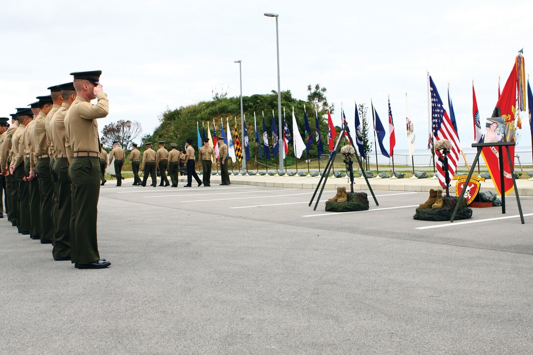 3rd Reconnaissance Battalion Marines salute their fallen brothers after a memorial service at Camp Schwab Feb. 3. The Marines died in combat in Afghanistan last year. Sgt. Daniel D. Gurr passed on Aug. 5, 2011. Cpl. Adam J. Buyes passed on Nov. 26. 3rd Recon Bn., 3rd Marine Division, III Marine Expeditionary Force, returned from a seven-month deployment in December 2011. 