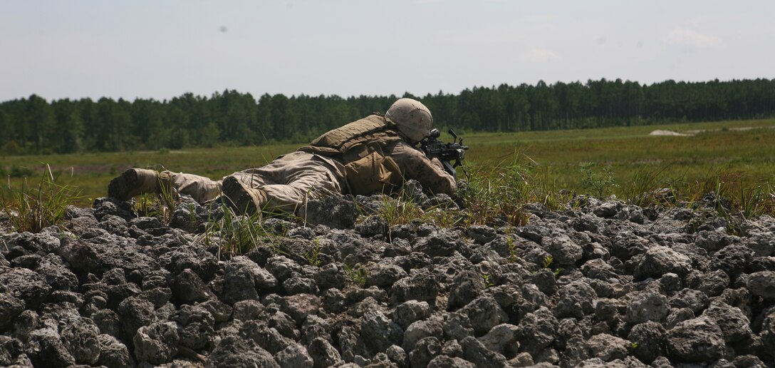 A Marine with 2nd Battalion, 6th Marine Regiment, 2nd Marine Division, sights in on some argets down range while participating in a live fire exercise July 27, 2011 aboard Marine Corps Base Camp Lejeune, N.C.. During the exercise, Marines with machine guns laid suppressive fire while other Marines with M-16’s and M-4’s moved closer to engage their respective targets.