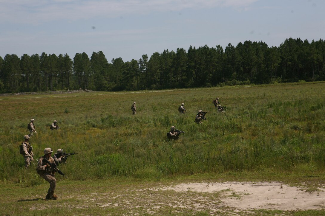 Marines with 2nd Battalion, 6th Marine Regiment, 2nd Marine Division, rush toward their respective targets while participating in a live fire exercise July 27, 2011 aboard Marine Corps Base Camp Lejeune, N.C.. During the exercise, Marines with machine guns laid suppressive fire while other Marines with M-16’s and M-4’s moved closer to engage their respective targets.