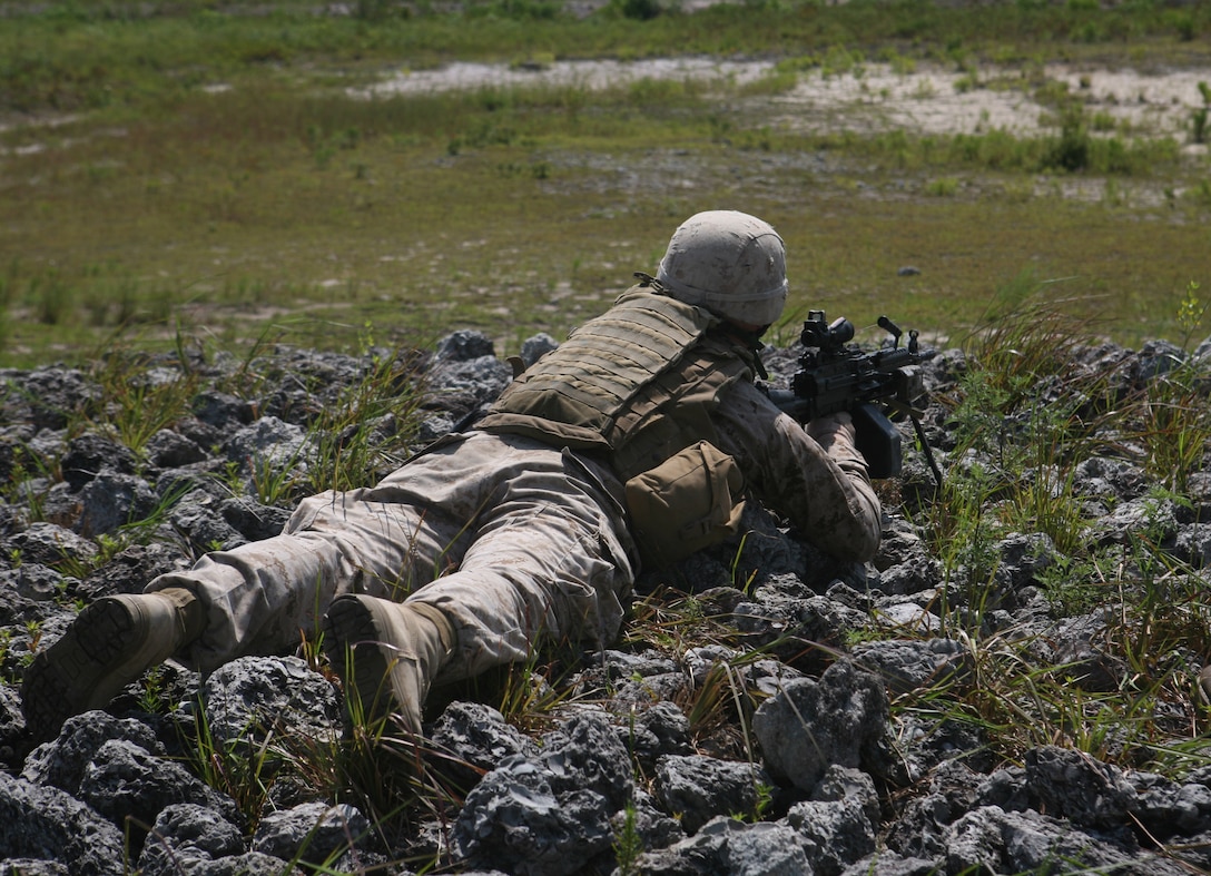 A Marine with 2nd Battalion, 6th Marine Regiment, 2nd Marine Division, sights in on some argets down range while participating in a live fire exercise July 27, 2011 aboard Marine Corps Base Camp Lejeune, N.C.. During the exercise, Marines with machine guns laid suppressive fire while other Marines with M-16’s and M-4’s moved closer to engage their respective targets.