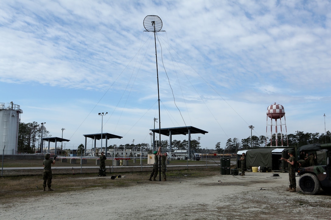 Marines with Communications Company, Combat Logistics Regiment 27, 2nd Marine Logistics Group raise an AN/MRC-142C antenna during a training exercise aboard Camp Lejeune, N.C., Feb. 29, 2012. During the exercise the participating Marines tested their capabilities in a simulated field environment in accordance with their training and readiness standards.