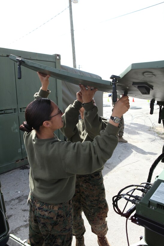 Pfc. Jennifer M. Castillo (foreground), a field radio operator, and Lance Cpl. Francis G. Perdomo (background), a satellite communications operator-maintainer both with Communications Company, Combat Logistics Regiment 27, 2nd Marine Logistics Group, assemble an satellite dish during a training exercise aboard Camp Lejeune, N.C., Feb. 29, 2012. During the exercise the participating Marines tested their capabilities in a simulated field environment in accordance with their training and readiness standards.