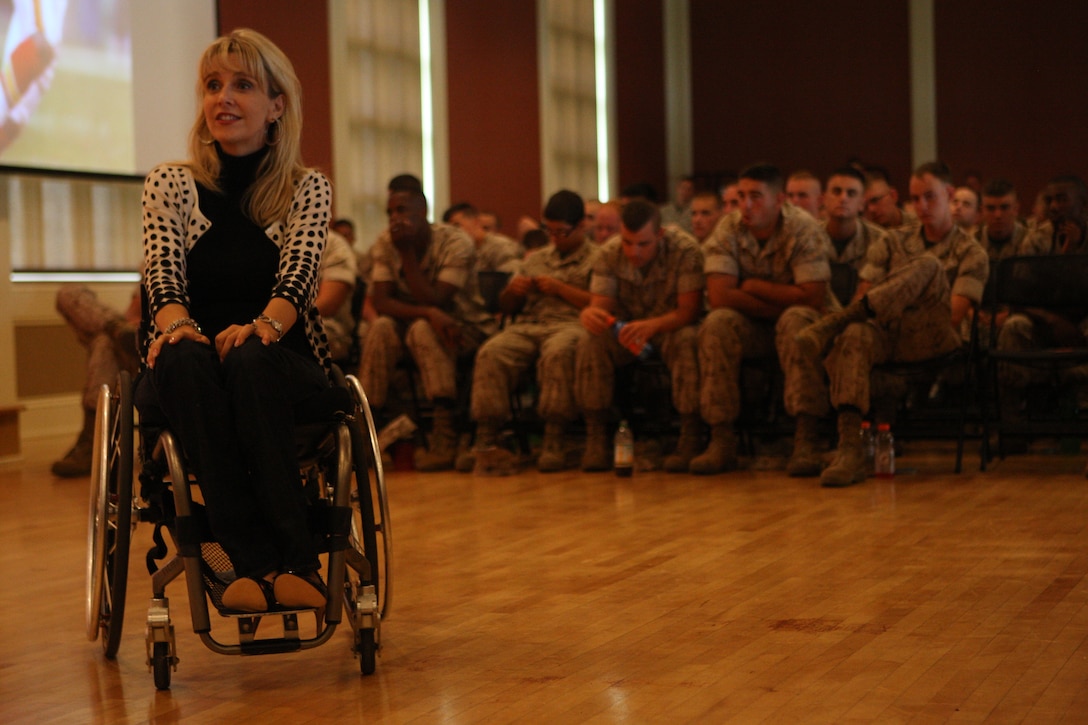 Kelly Narowski, a paraplegic due to a debilitating vehicle wreck, speaks to Marines and sailors about her experiences as well as those of others in the Tinian Room of Marston Pavilion aboard Marine Corps Base Camp Lejeune, July 27. Narowski stressed the importance of making smart decisions in the vehicle and not to let the split-second decisions that can drastically alter one’s life be made hastily.