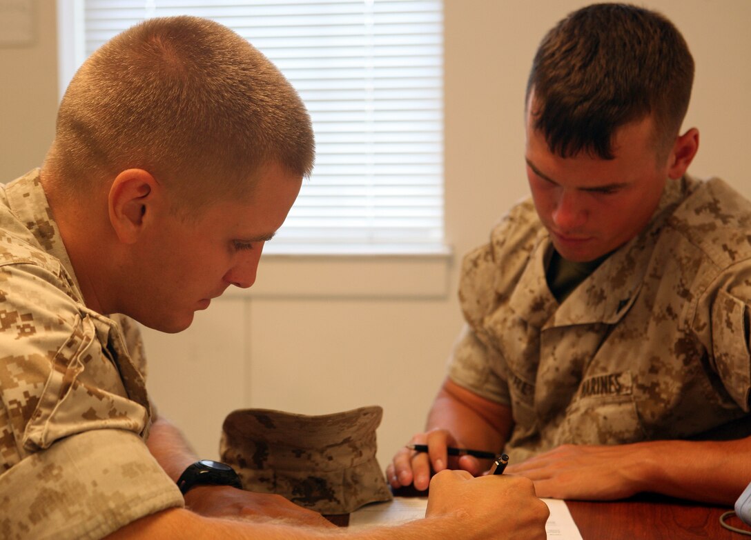 Seaman Joshua Shoemake, a hospital corpsman with Headquarters Battalion, 2nd Marine Division, assists a Marine at the Headquarters Battalion Aid Station aboard Marine Corps Base Camp Lejeune, N.C. July 22, 2011. Shoemake, from Phoenix, has impressed his command with his leadership ability and constant drive for self-improvement since arriving to the battalion in January.