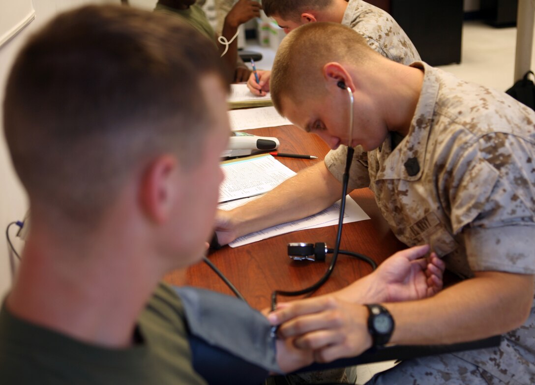 Seaman Joshua Shoemake, a hospital corpsman with Headquarters Battalion, 2nd Marine Division, takes a Marine’s blood pressure at the Headquarters Battalion Aid Station aboard Marine Corps Base Camp Lejeune, N.C. July 22, 2011. The ever-motivated Shoemake aspires to one day become a Navy SEAL.