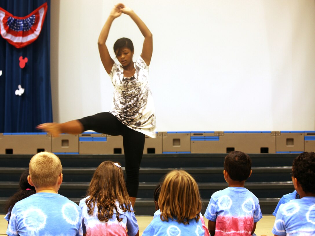 Costa Constantinou, a music specialist with Delalio Elementary School aboard Marine Corps Air Station New River, dances for the students of the Tarawa Terrace II Elementary School as part of the End of the Summer School Celebration, July 22.