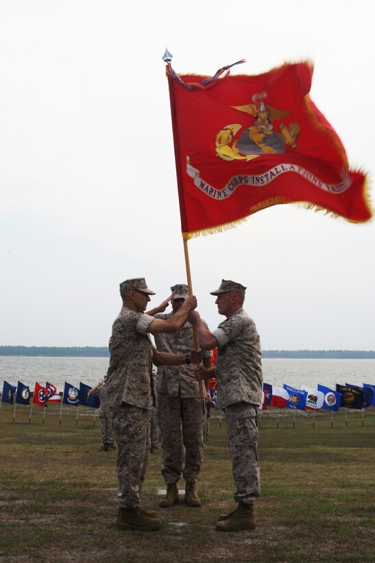 Maj. Gen. Carl B. Jensen (right), commanding general of Marine Corps Installations East, turns over the colors and his position to Col. Thomas A. Gorry, brigadier general select, during the MCIEAST change of command ceremony at the 2nd Marine Logistics Group Amphitheater, July 22. Gorry, who comes to MCIEAST from his previous assignment as the director of the Command and Staff College, Marine Corps University, takes charge as the third ever MCIEAST commander.