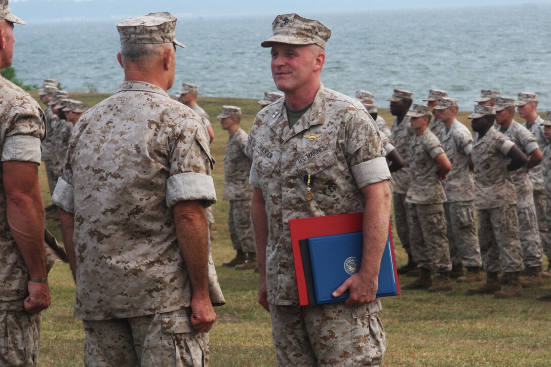 Maj. Gen. Carl B. Jensen (right), outgoing commanding general of Marine Corps Installations East, stands in front of Lt. Gen. Dennis J. Hejlik, commanding general of Fleet Marine Forces Atlantic; Marine Corps Bases Atlantic and United States Marine Corps Forces Command, after being awarded a Distinguished Service Medal, certificates of appreciation from the President Barack Obama and Secretary of the Navy Ray Mabus, and the Order of the Longleaf Pine from Bev Perdue, governor of North Carolina, making Jensen an “ambassador extraordinary” of North Carolina during the MCIEAST change of command ceremony and Jensen’s retirement at the 2nd Marine Logistics Group Amphitheater, July 22.