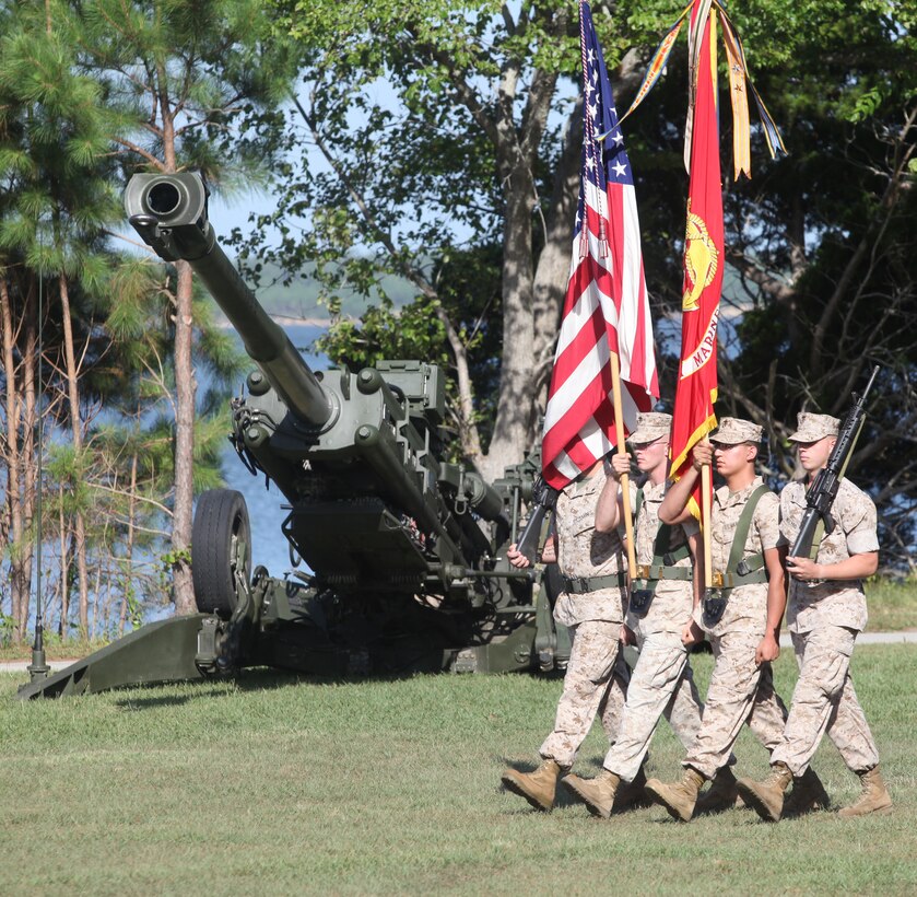 A color detail with 10th Marine Regiment, 2nd Marine Division, presents the unit colors to their commanders during a change of command ceremony July 15, 2011, aboard Marine Corps Base Camp Lejeune, N.C. Col. Phillip W. Boggs relinquished his duties as commanding officer of 10th Marine Regiment, 2nd Marine Division, to Col. Bradley R. Hall.