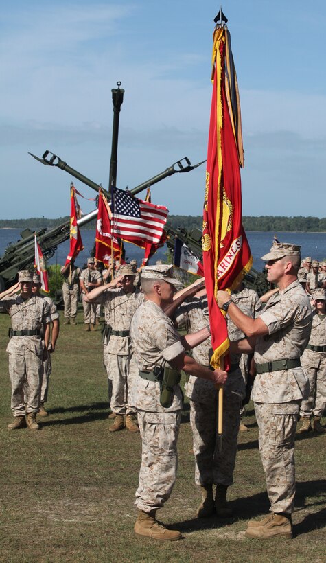 Col. Phillip W. Boggs, (right), relinquishes his duties as commanding officer of 10th Marine Regiment, 2nd Marine Division, to Col. Bradley R. Hall during a change of command ceremony July 15, 2011, aboard Marine Corps Base Camp Lejeune, N.C.