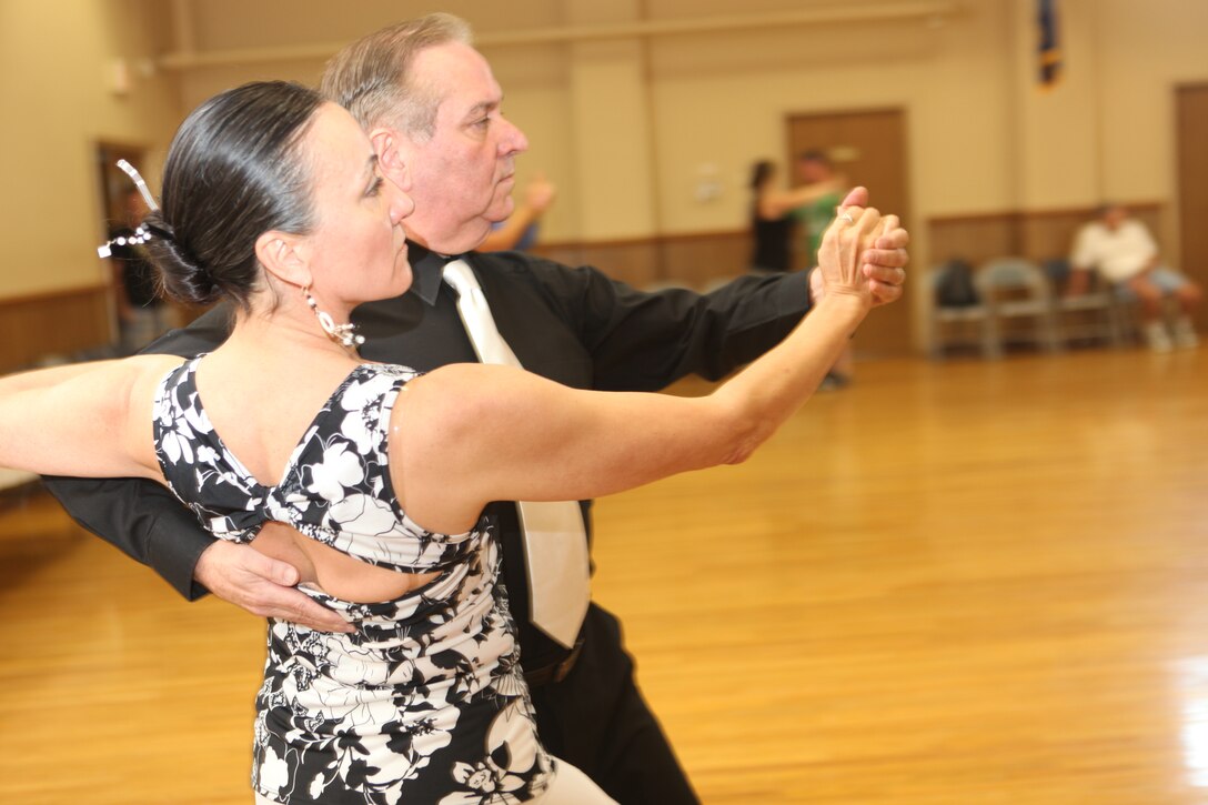 John and Penny DeFino, local competitive dancers, tango dance during the ballroom dance class held at the USO of North Carolina Jacksonville Center, Saturday. Every third Saturday, the USO holds the monthly event for anyone wanting to participate, whether it be competitive dancers, beginners, children, adults or seniors.