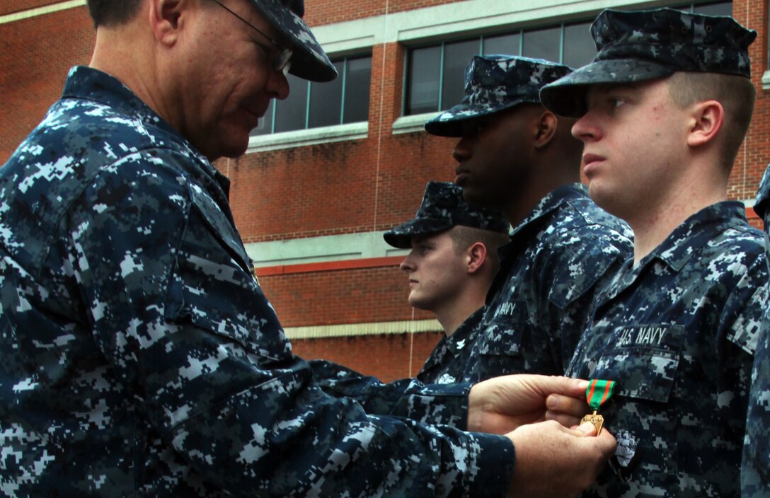 Seaman Brett R. Hodgson, a hospital corpsman with Cherry Point Naval Health Clinic, is awarded the Navy and Marine Corps Achievement Medal for providing basic life support to Kim Robinson and her two children, Collin and Carlee, who were involved in a head-on collision last April.