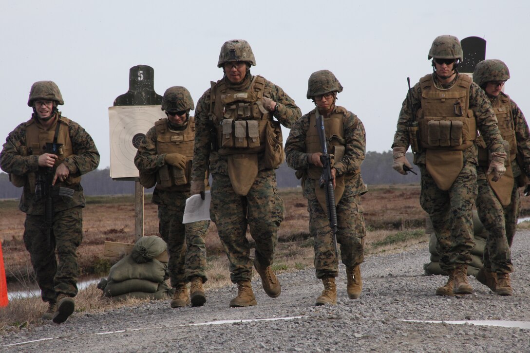 Marines from 2nd Low Altitude Air Defense Battalion walk back to the firing line after the weapons sight adjustment phase of fire portion of a small arms shoot, Mar. 8 during Exercise Sandman. “The purpose of this training was to gain experience conducting a combat operations center, become more proficient at firing 5.56mm rounds and get hands on experience with the Stinger Missile,” said Capt. Leonard J. Niedosik, the Battery A 2nd Low Altitude Air Defense Battalion commanding officer.
