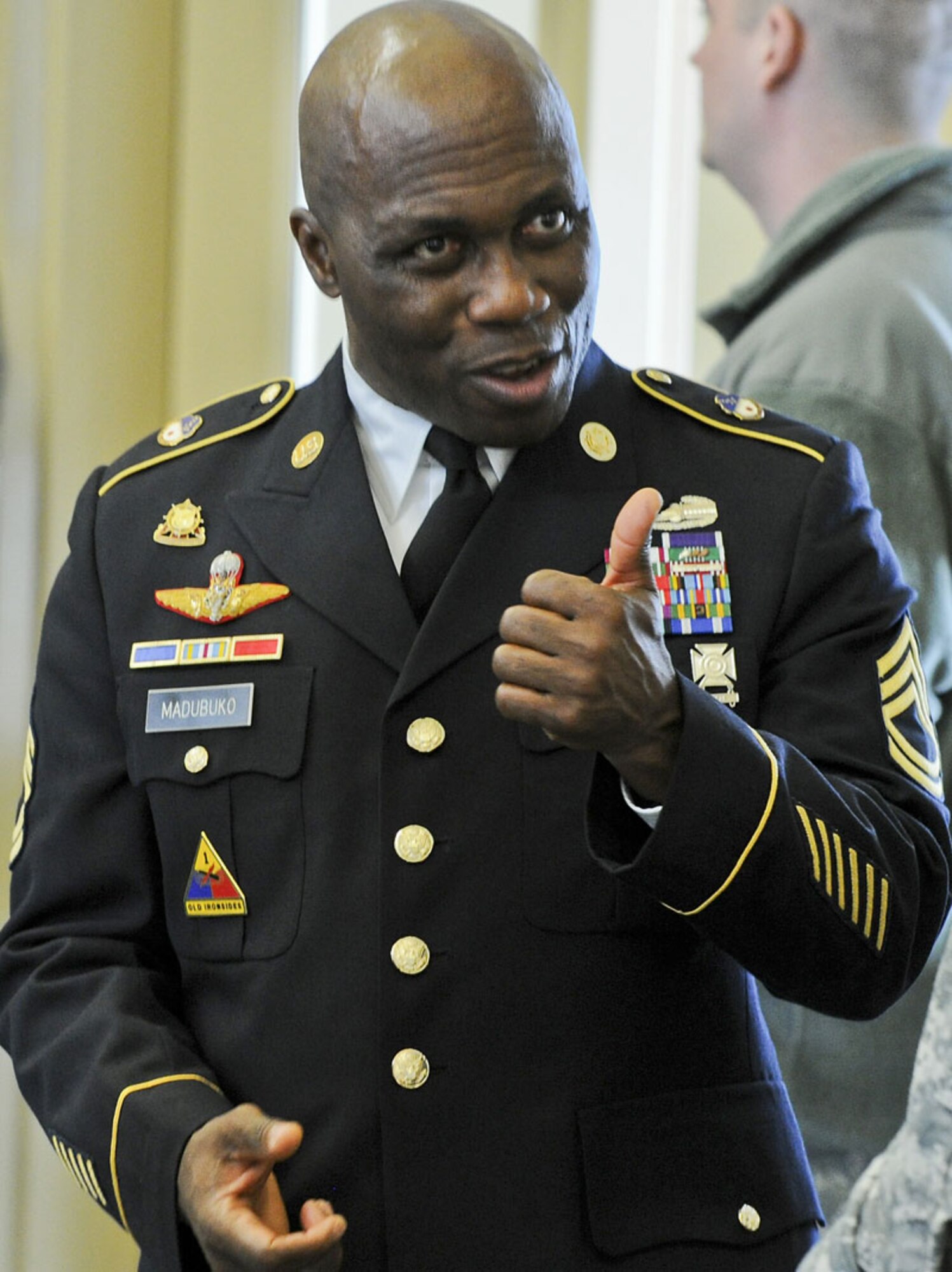 Warrior Transition Battalion Soldier Sgt. 1st Class Kelechi Madubuko of Washington D.C., a Purple Heart Medal recipient who was wounded in Iraq in 2003, gives a “thumbs up” to a fellow Soldier before the ribbon cutting ceremony celebrating official opening the Warrior Transition Battalion-Alaska on JBER Friday, with guest speaker Maj. Gen. Raymond Palumbo, commanding general United States Army Alaska and Alaska Gov. Sean Parnell among other distinguished dignitaries.  (U.S. Air Force photo/Justin Connaher)