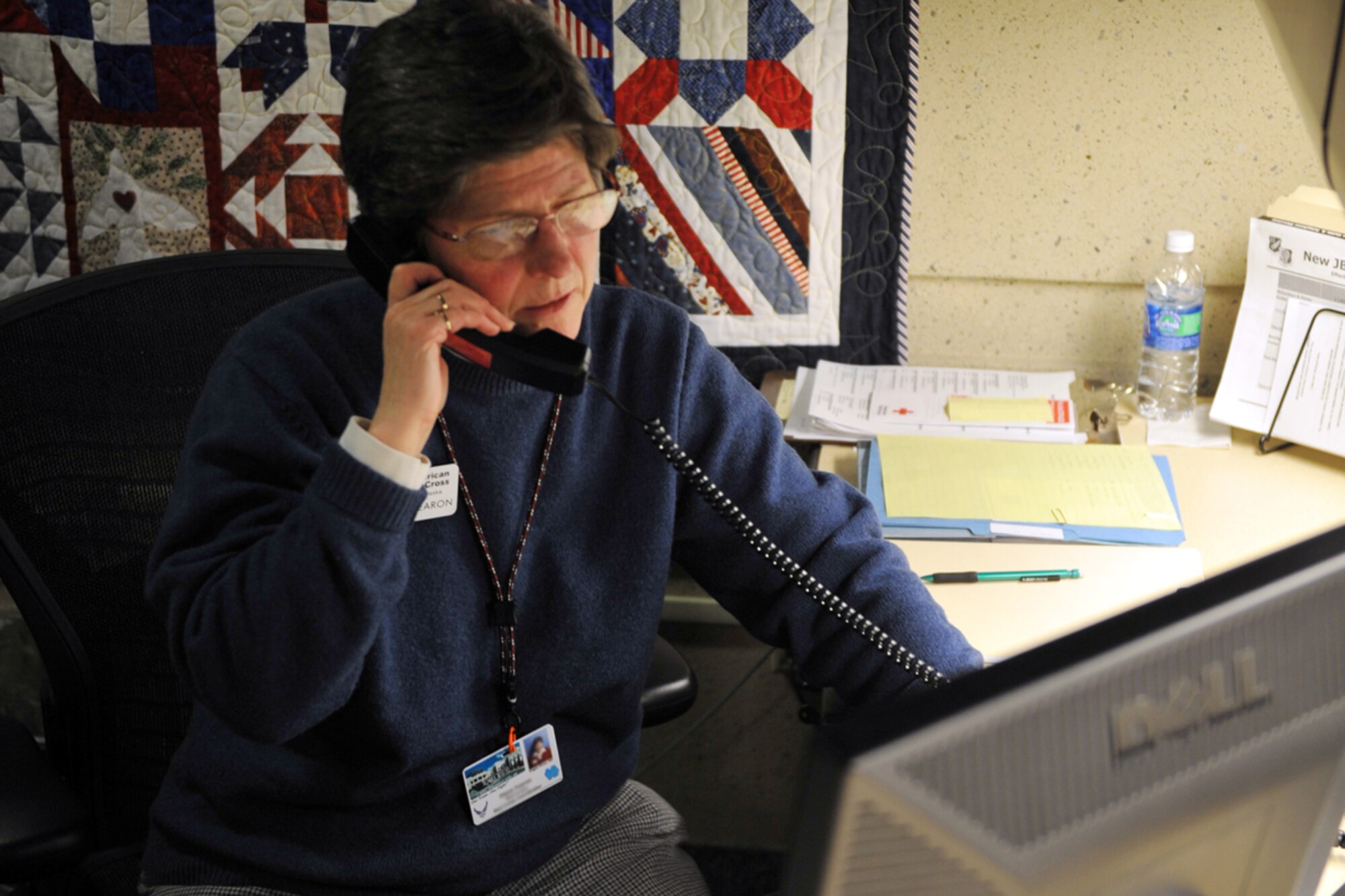 JOINT BASE ELMENDORF-RICHARDSON -- The Red Cross divison's Diane Fearon takes an incoming call from her desk at the JBER hospital on Dec. 2. Fearons's main duty as a Red Cross representative is to ensure the well-being and stability of service members and their family members alike.(U.S. Air Force photo/Airman 1st Class Ty-Rico Lea)