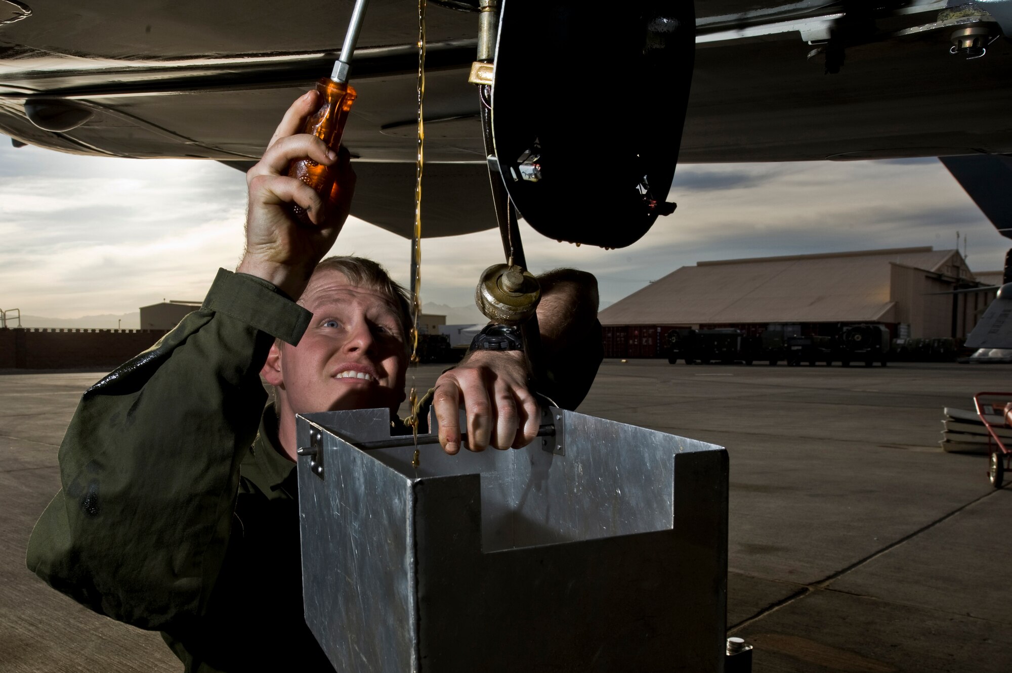 Royal Air Force of the United Kingdom Corporal Craig Godbolo, 2nd Army Cooperation Squadron, avionics technician, RAF Marham, replenishes oil on a GR4 Tornado, during Red Flag 12-3 March 5, 2012, at Nellis Air Force Base, Nev. Red Flag is a realistic combat training exercise involving the air forces of the United States and its allies.(U.S. Air Force photo by Airman 1st Class Daniel Hughes)