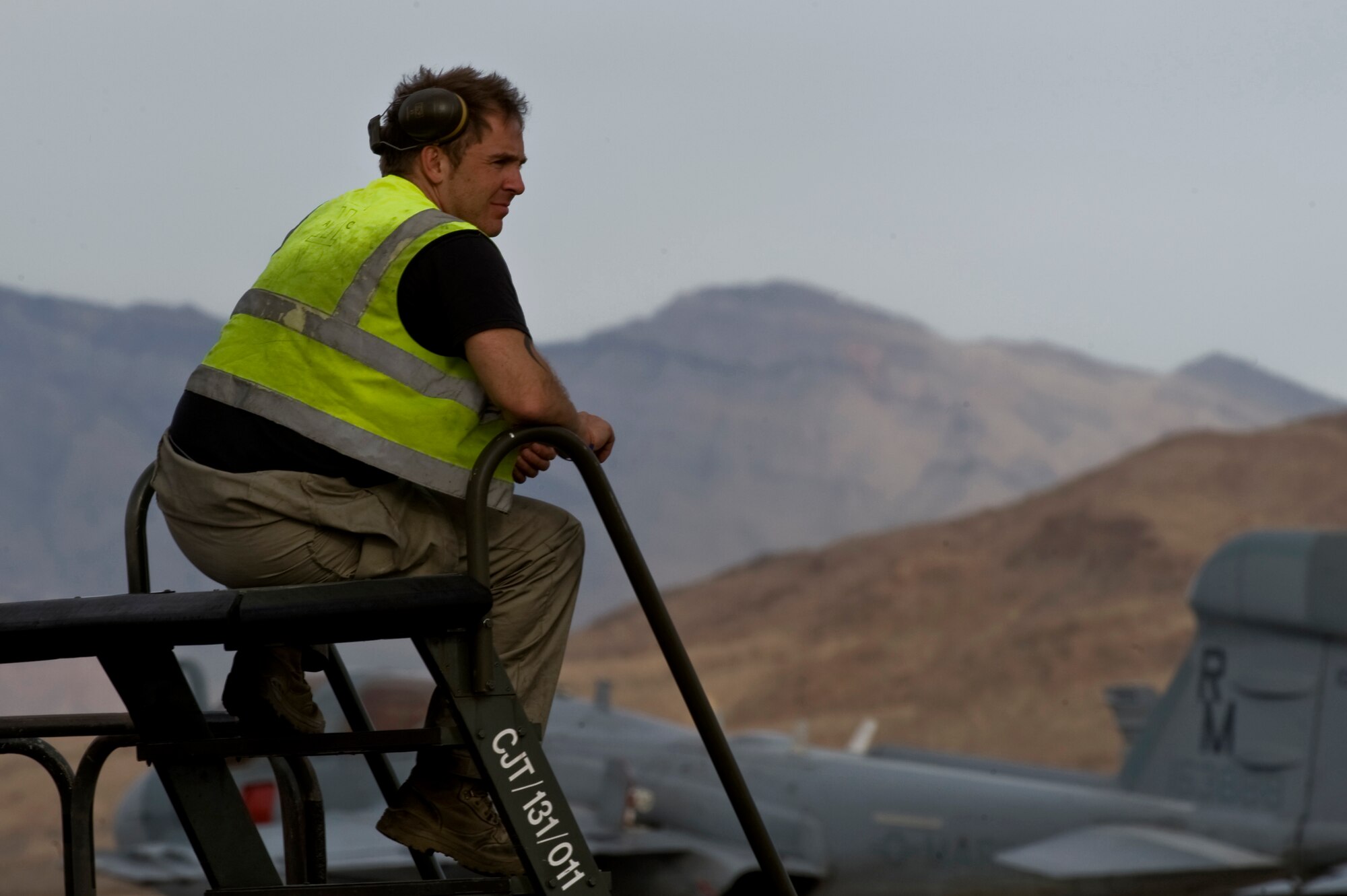 Royal Air Force of the United Kingdom Senior Aircraftsman, Chris Mather, 2nd Army Cooperation Squadron, avionics technician, RAF Marham, watches aircraft taxi and launch on the flightline, during Red Flag 12-3 March 5, 2012, at Nellis Air Force Base, Nev. Red Flag is a realistic combat training exercise involving the air forces of the United States and its allies.(U.S. Air Force photo by Airman 1st Class Daniel Hughes)