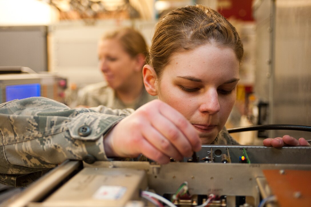 Airman 1st Class Cassandra Mallory, 28th Communications Squadron airfield systems technician, troubleshoots a radio at Ellsworth Air Force Base, S.D., March 6, 2012. The airfield systems section is responsible for maintaining all radio communications, weather systems, and directional equipment used to guide aircraft during landings. (U.S. Air Force photo by Airman Alystria Maurer/Released)