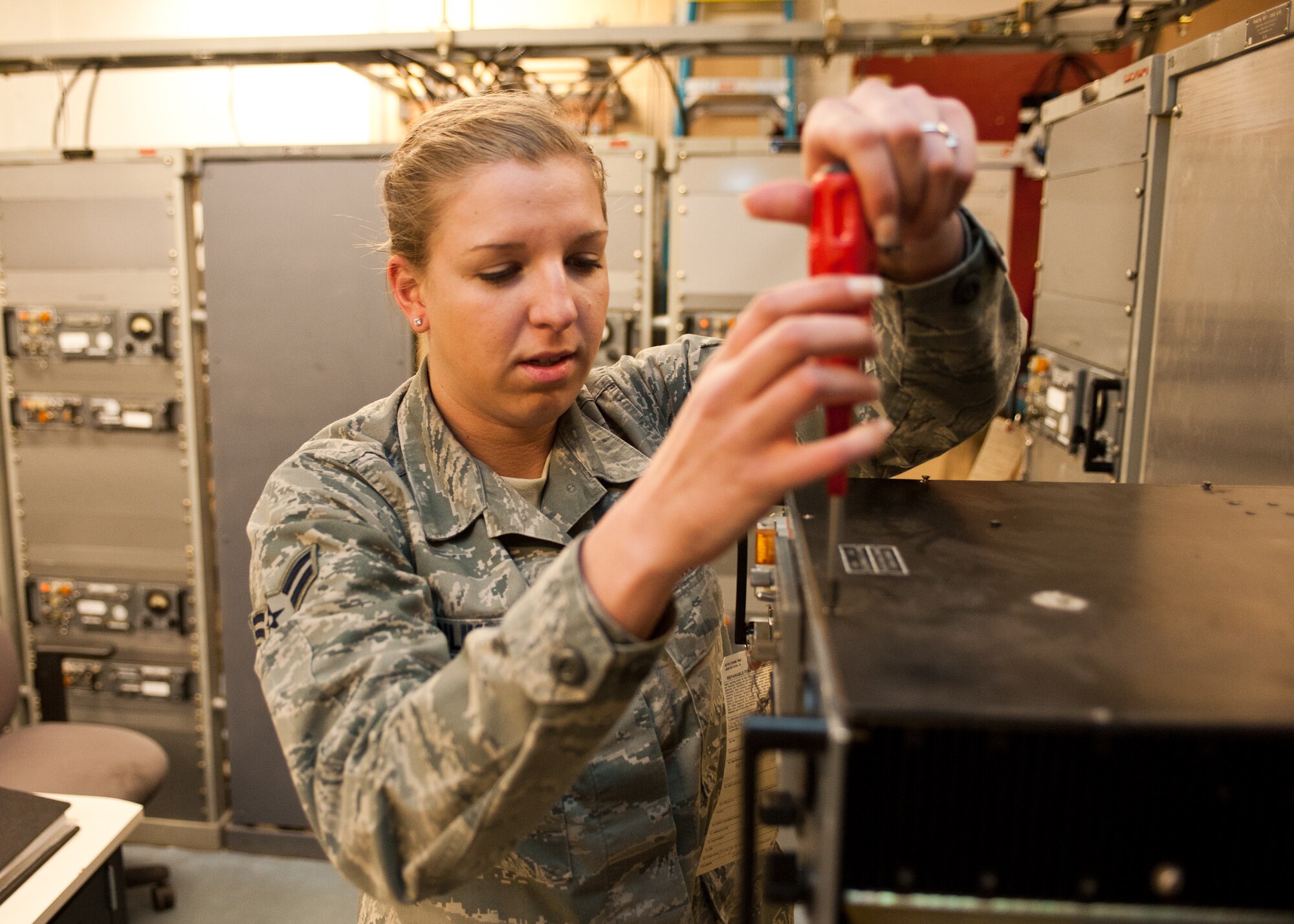 Airman 1st Class Taylor Anliker, 28th Communications Squadron airfield systems technician, opens a radio transmitter for calibration at Ellsworth Air Force Base, S.D., March 6, 2012. The radio transmitter must be calibrated to ensure seamless communication between the base control tower and aircrews. (U.S. Air Force photo by Airman Alystria Maurer/Released)