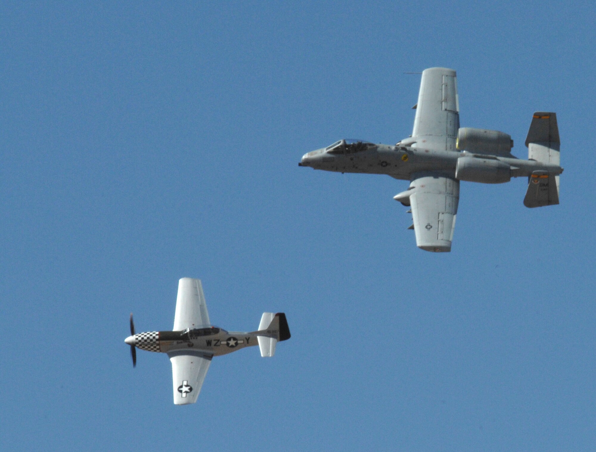 A P-51 Mustang and A-10 Thunderbolt perform an aerial maneuver at the Heritage Flight Conference on Davis-Monthan Air Force Base, Ariz., March 3. (U.S. Air Force photo by Airman 1st Class Michael Washburn/Released)
