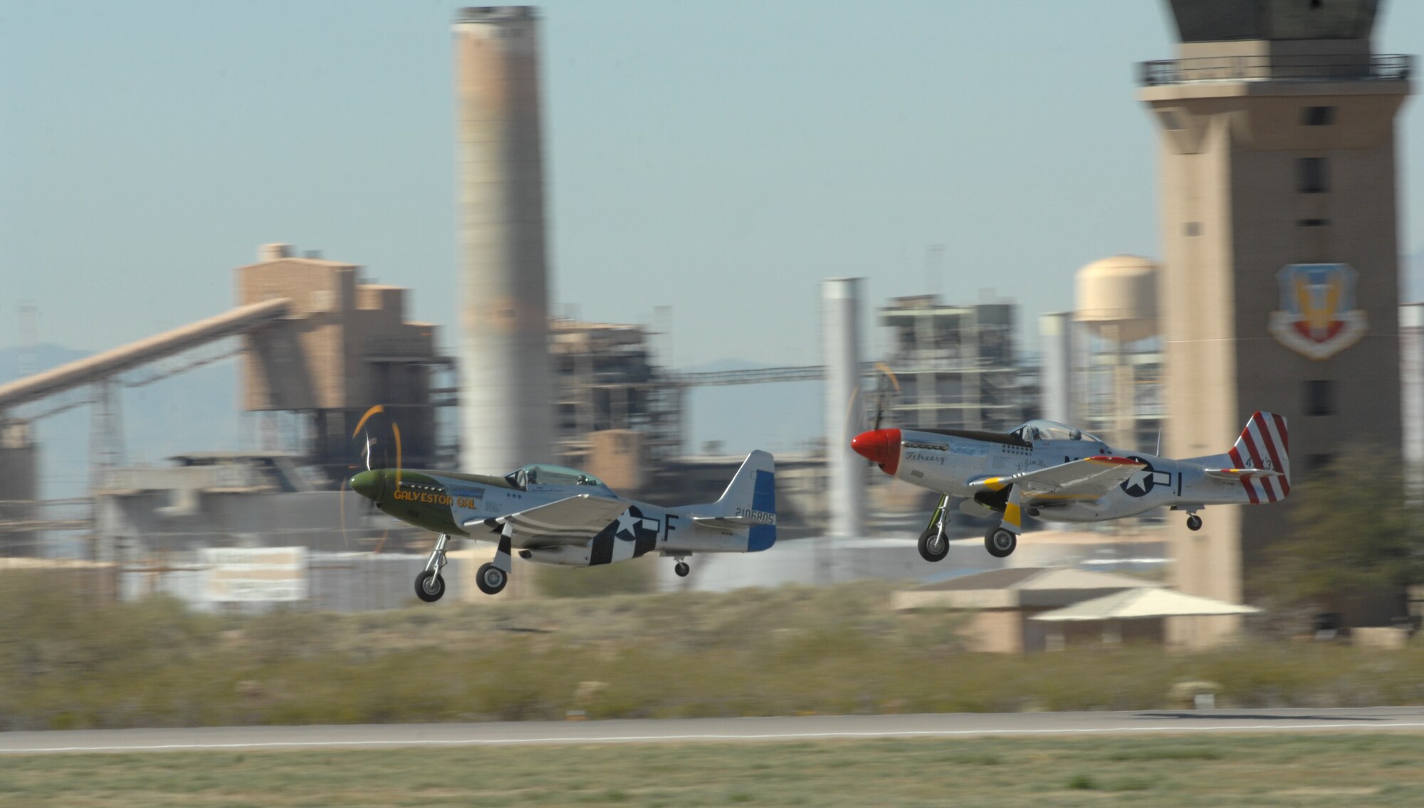 Two P-51 Mustang aircrafts perform a dual takeoff at the Heritage Flight Conference on Davis-Monthan Air Force Base, Ariz., March 3. (U.S. Air Force photo by Airman 1st Class Michael Washburn/Released)