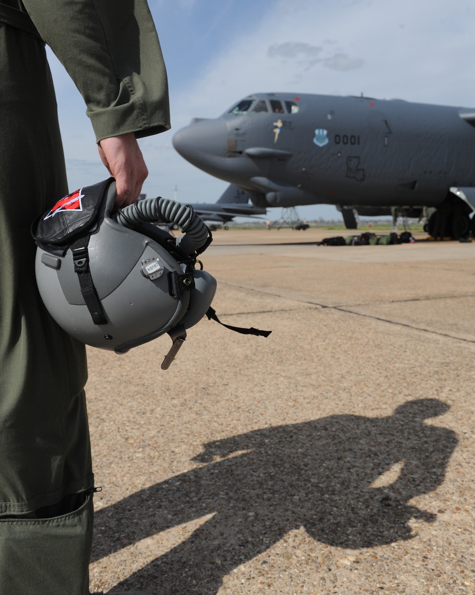 1st Lt. Mason Martin, 96th Bomb Squadron, holds an aircrew helmet in front of a B-52H Stratofortress on Barksdale Air Force Base, La., March 6. Airmen from the 2nd Operation Support Squadron aircrew flight equipment manage, maintain and service aircrew members' helmets, parachutes and survival equipment. When aircrews return to base, AFE Airmen ensure all their equipment is in working order for the next mission. (U.S. Air Force photo/Airman 1st Class Micaiah Anthony)(RELEASED)
