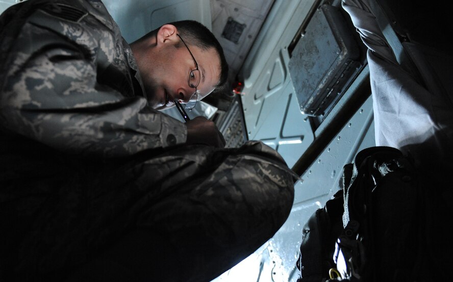 Tech. Sgt. Wesley Vinson, 2nd Operation Support Squadron aircrew flight equipment, documents his findings during a parachute inspection inside a B-52H Stratofortress on Barksdale Air Force Base, La., March 6. AFE Airmen look for grease and ensure the parachutes are dry as a part of their inspection.  (U.S. Air Force photo/Airman 1st Class Micaiah Anthony)(RELEASED)