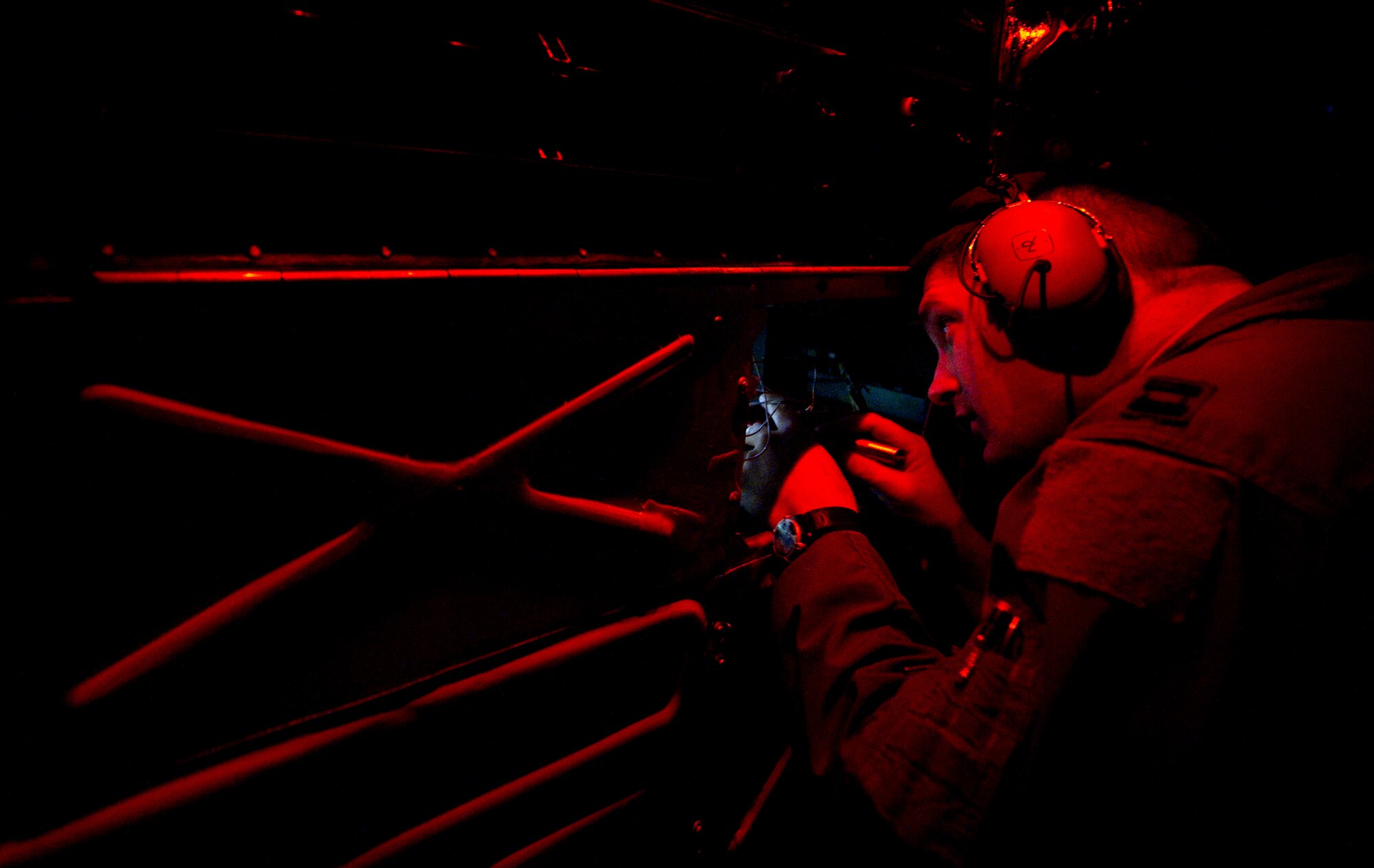 Capt. Ryan King, a B-52H Stratofortress instructor navigator from the 96th Bomb Squadron, Barksdale Air Force Base, La., inspects a maintenance issue during Exercise Red Flag, March 3, 2012. Red Flag trains pilots from the U.S., NATO and other allied countries for realistic combat scenarios. The B-52 performs a dual-role mission, nuclear and conventional, providing a rapid global strike capability and ability to reach hardened and buried targets anywhere and at anytime. (U.S. Air Force photo by Tech. Sgt. Bradley C. Church)(Released)
