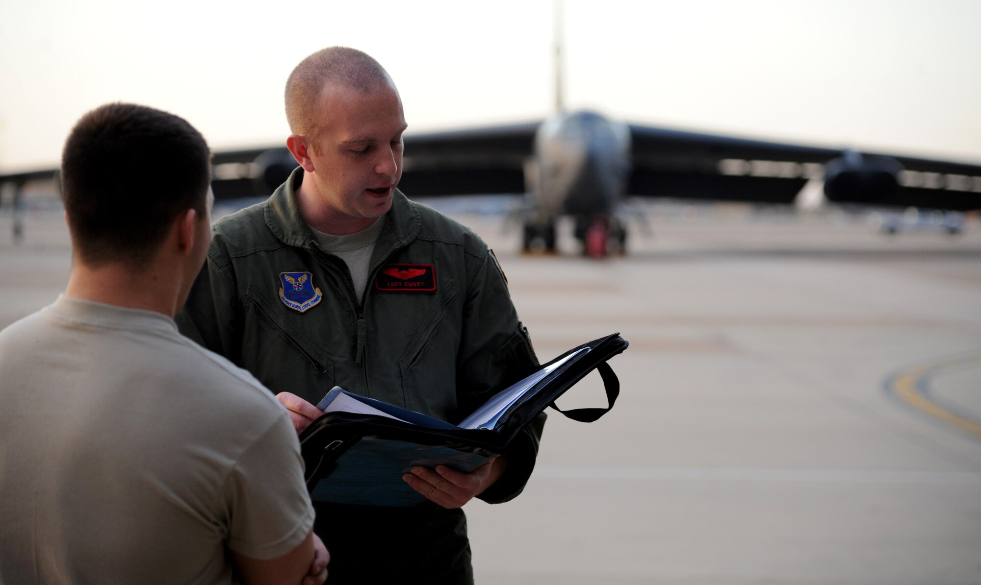 Capt. Andrew Embry, a B-52H Stratofortress aircraft commander from the 96th Bomb Squadron, Barksdale Air Force Base, La., reviews aircraft paperwork with Airman1st Class Jake Corthas, a crew chief from the 2nd Aircraft Maintenance Squadron at Barksdale, before a mission during Exercise Red Flag, March 3, 2012. Red Flag trains pilots from the U.S., NATO and other allied countries for realistic combat scenarios.  The exercise provides an opportunity for Air Force Global Strike Command units to demonstrate conventional strike capability, anytime and anywhere. (U.S. Air Force photo by Tech. Sgt. Bradley C. Church)(Released)
